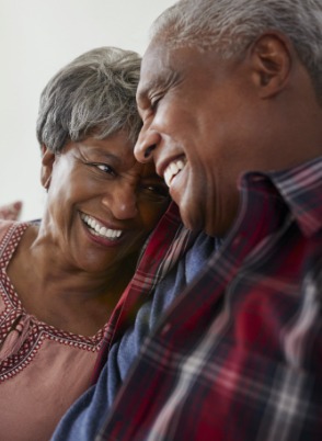 Senior man and woman laughing and holding each other