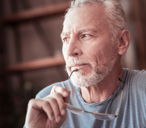 Man considering tooth replacement with all on four dental implants