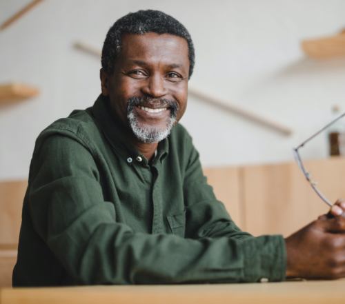 Man sharing healthy smile after gum grafting and recontouring treatment