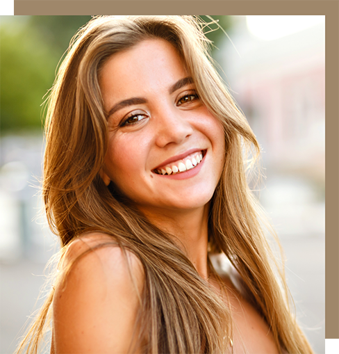 Young blonde woman smiling outdoors