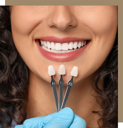 Woman smiling in front of a row of veneers