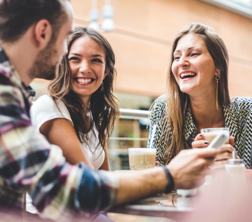 Group of friends laughing after dental crown restorations