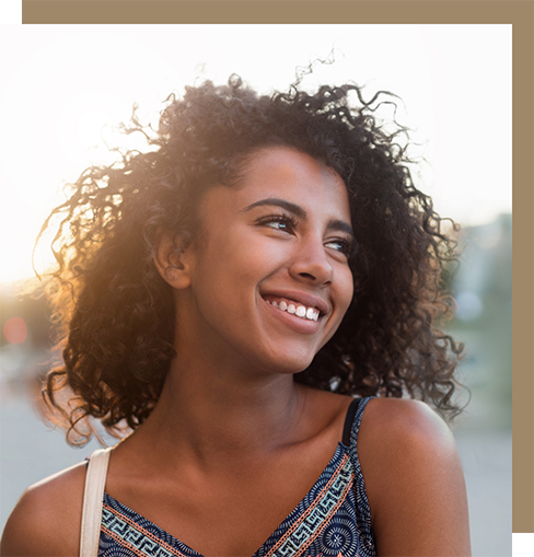 Young woman smiling at sunset