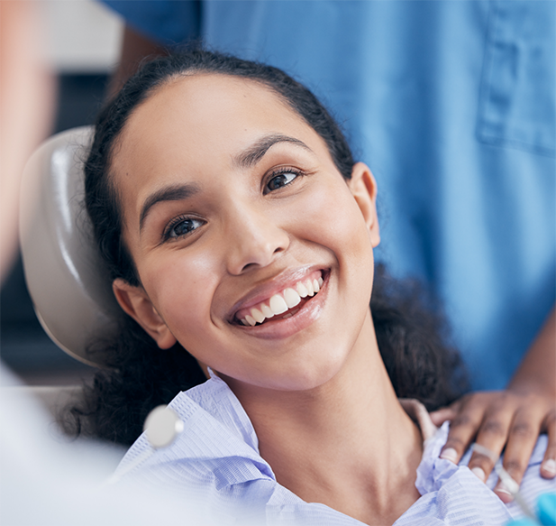 Young woman smiling during her dental checkup and cleaning in Cocoa Beach