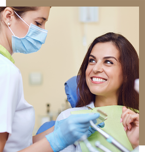 Woman smiling at a dental team member during her appointment