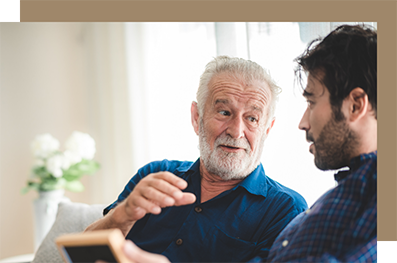Man talking with his father on a couch