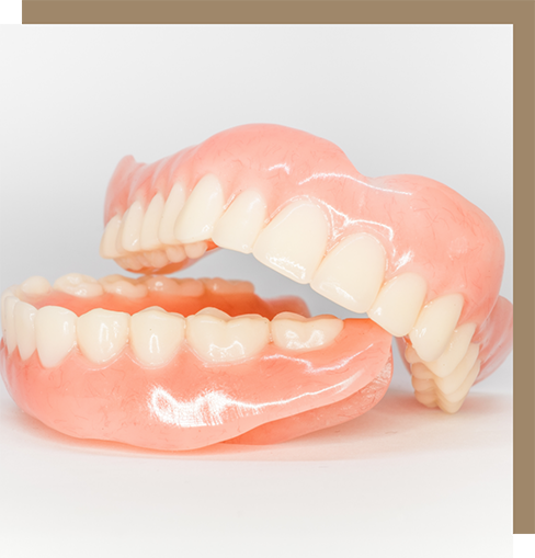 Two full dentures on a flat white surface