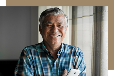 Smiling older man in a green plaid shirt