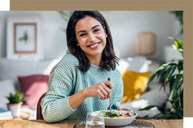 Woman smiling with a bowl of salad