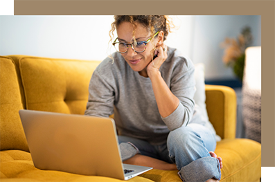Woman using a laptop on a couch