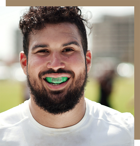 Athlete wearing a bright green mouthguard