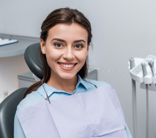 Woman smiling after tooth colored filling restoration