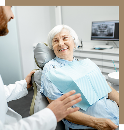 Senior woman smiling with her dentist at a consultation