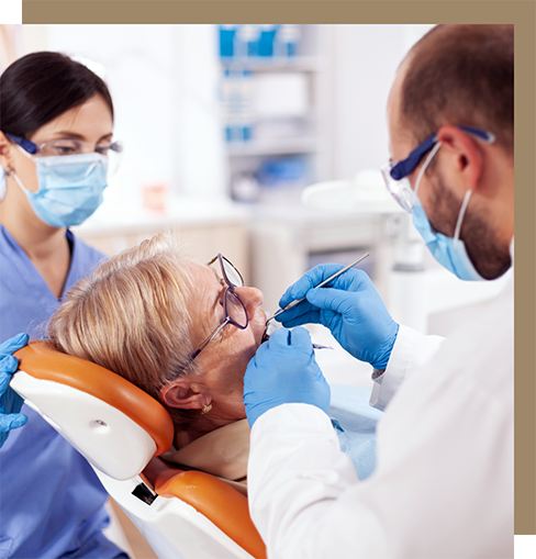 Dentist examining a senior woman's teeth