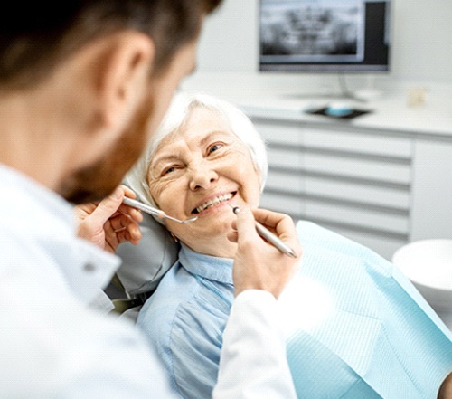 senior woman talking to her dentist about dental implants in Cocoa Beach
