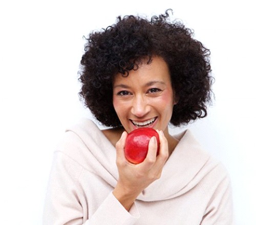 woman biting into a red apple