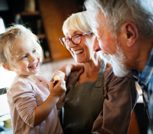 Older man and woman smiling after dental implant placement