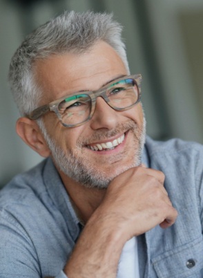Senior man with beard and glasses smiling