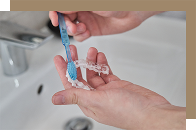 Cleaning clear aligner with toothbrush