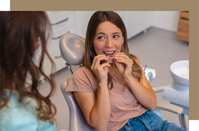 Woman at the dentist putting in clear aligners