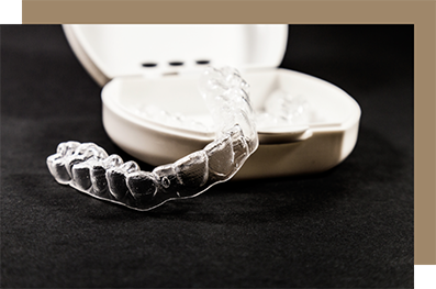 Two clear aligners in white plastic case