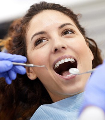 Woman with brown hair undergoing dental exam