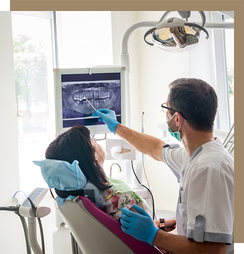 Dentist showing a patient an x-ray of their teeth