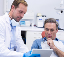 Patient and dentist reviewing information on tablet