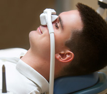 Patient relaxing while breathing in nitrous oxide in treatment chair