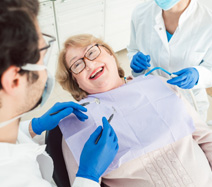 Patient smiling at dentist sitting in treatment chair