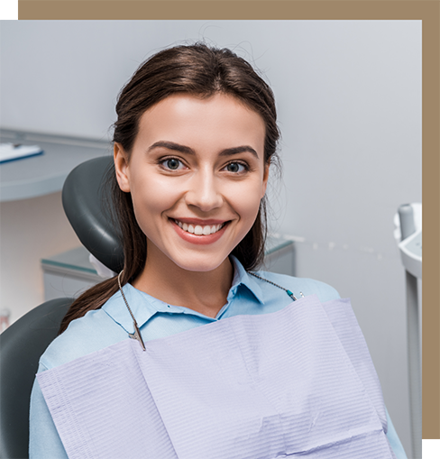 Young brunette woman sitting expectantly in the dental chair