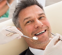 Man receiving an oral cancer screening