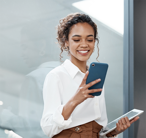 Woman in professional attire using her phone to request a dental appointment