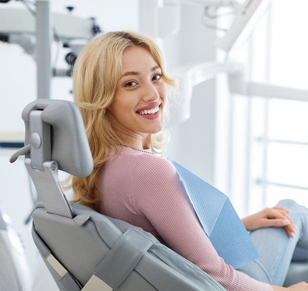 Woman in a pink blouse visiting the dentist