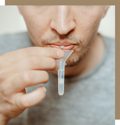 Man drooling into a funnel going into a vial