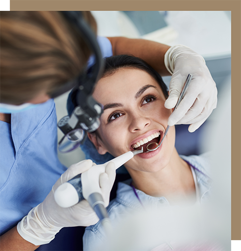 Dentist examining a woman's teeth and gums