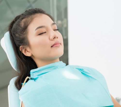 Patient relaxing in dental chair thanks to sedation dentistry