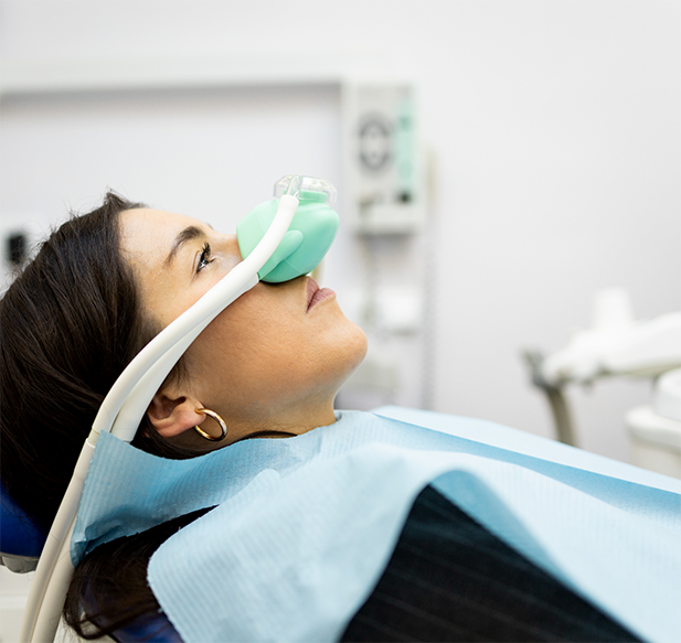 Dental patient with a nitrous oxide mask over her nose