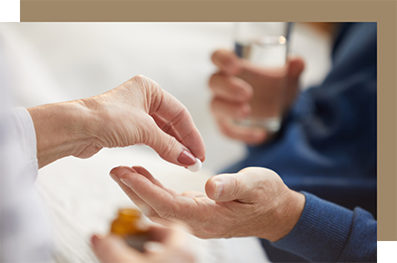 Person handing someone else a pill