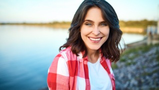 Woman with healthy smile thanks to preventive dentistry