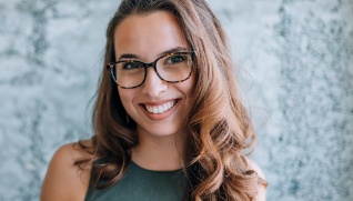 Woman with flawless smile after orthodontic treatment