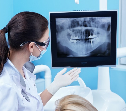 Dentist looking at digital dental x-rays