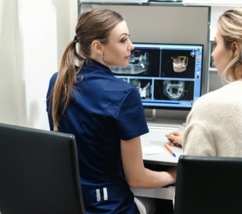 Dental team members reviewing C T imaging