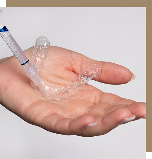 Person putting whitening gel into a tray for the teeth