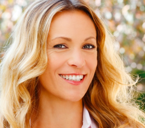 Woman with porcelain veneers smiling