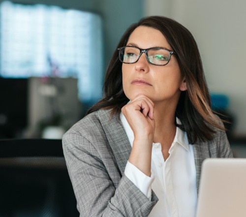 Woman contemplating frequently asked questions about porcelain veneers