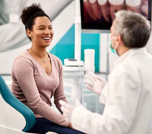 dentist and patient talking during appointment in office