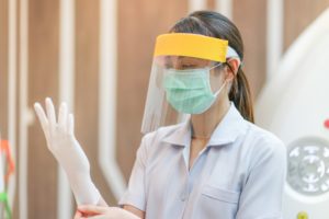 Dentist putting on PPE in a clean dental office 