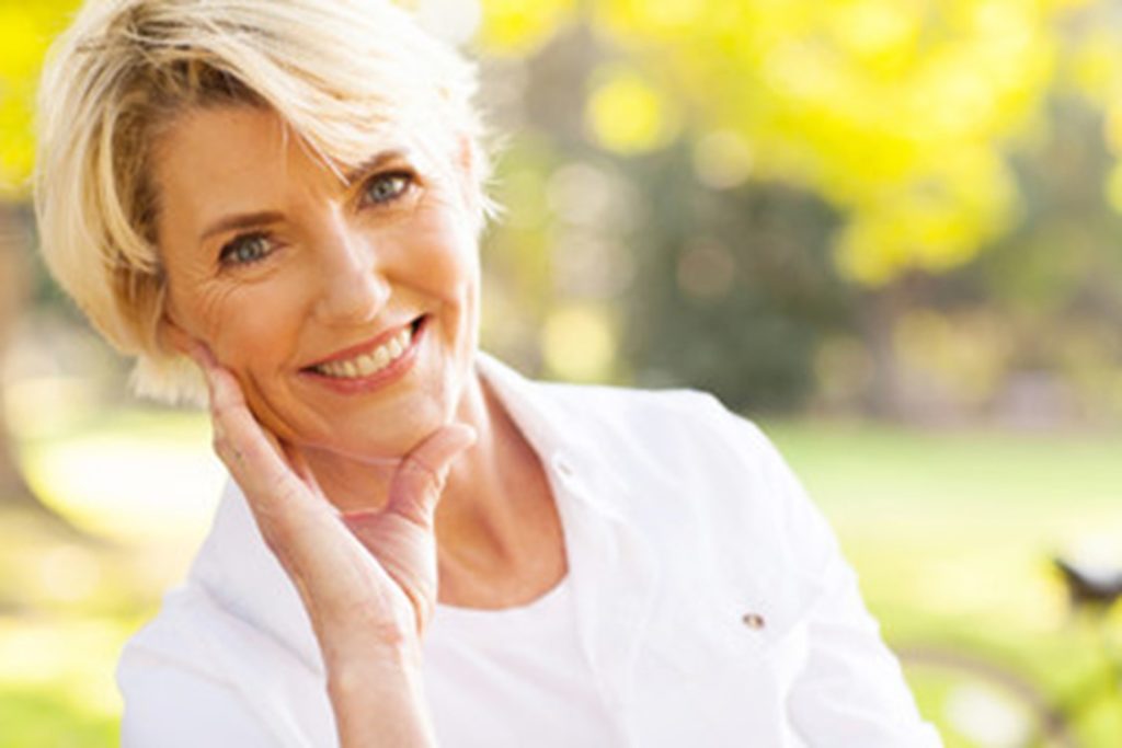 Woman who has received dental implants.