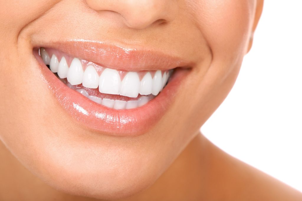 Closeup of person with white teeth smiling
